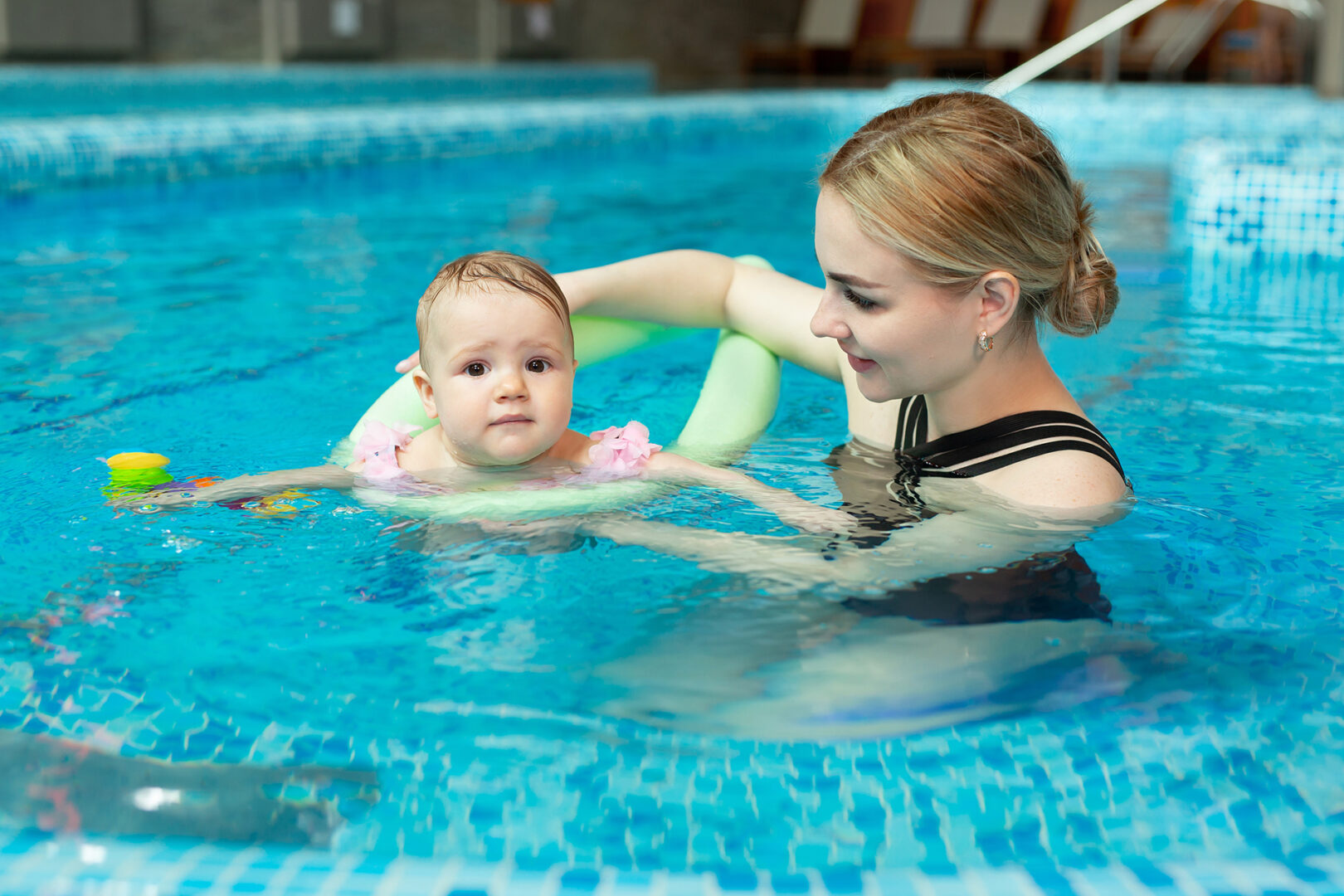 Underwater child swim in water swimming pool. Summer activity and healthy kids lifestyle. Summer vacation with children in a tropical resort. Kid boy with thumbs up under water.